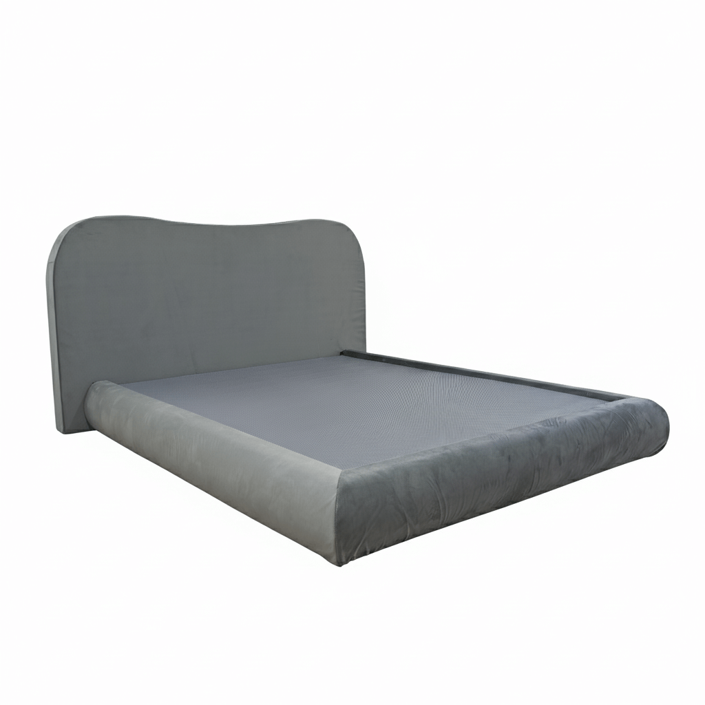 hree-quarter perspective of a contemporary gray velvet-textured bed frame featuring a sleek camelback silhouette and soft-wrapped edges