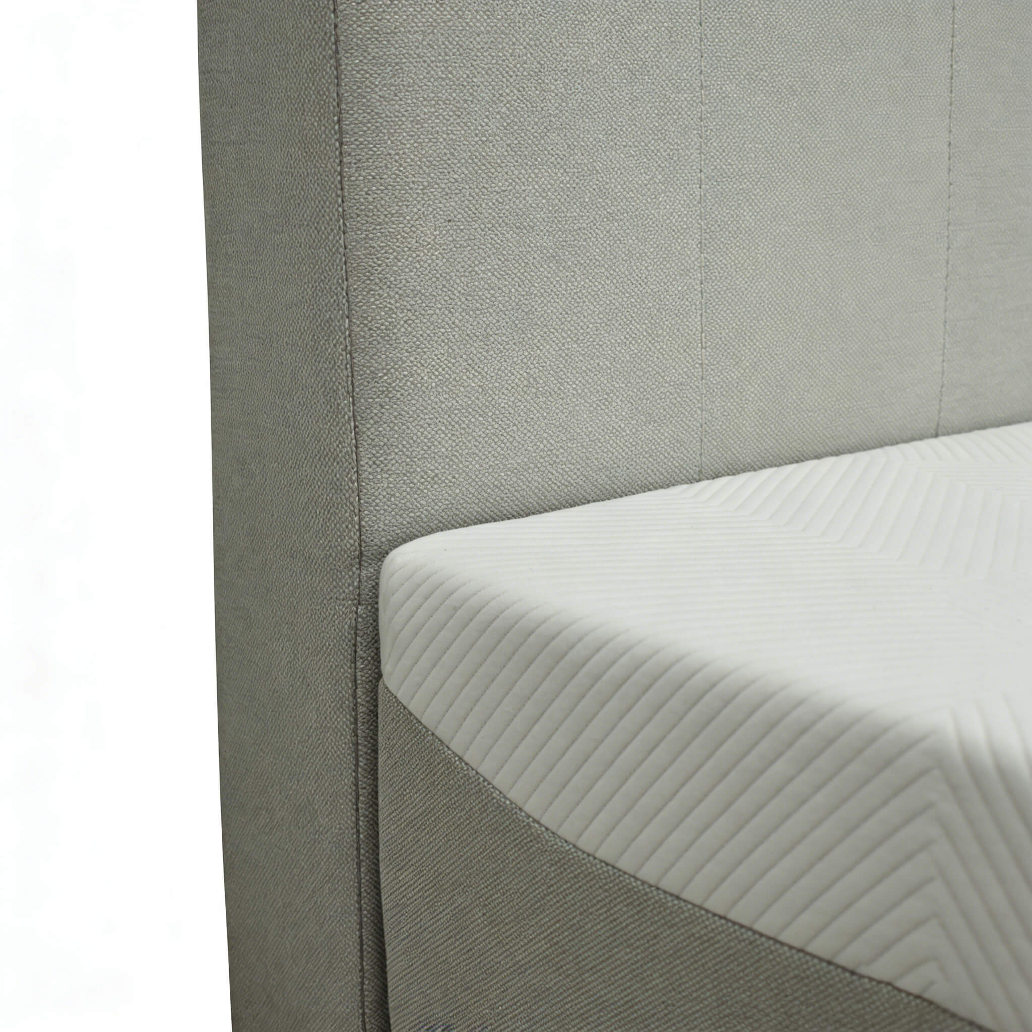 Close-up of high-quality upholstery and precision stitching on the integrated all-foam bed, showing the durable fabric texture and reinforced corner support