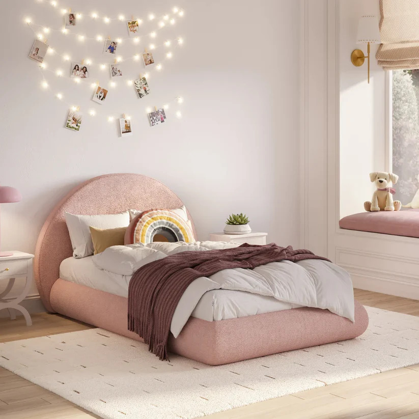 Modern minimalist kids bedroom setup featuring a pink boucle fabric upholstered bed with 