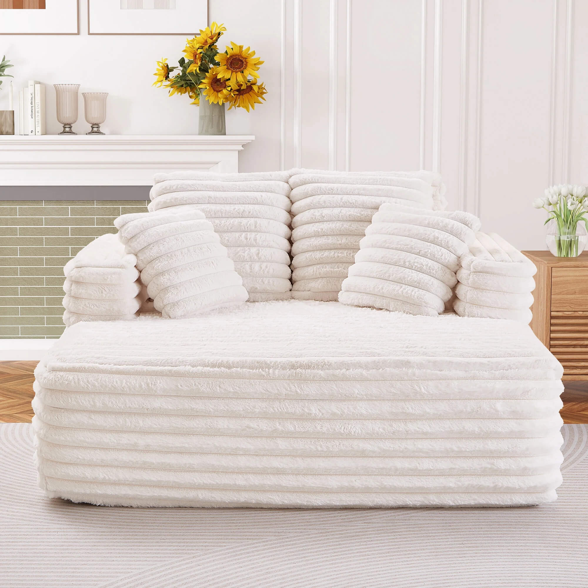 White oversized faux fur sleeper chair with ribbed texture and matching pillows for living room
